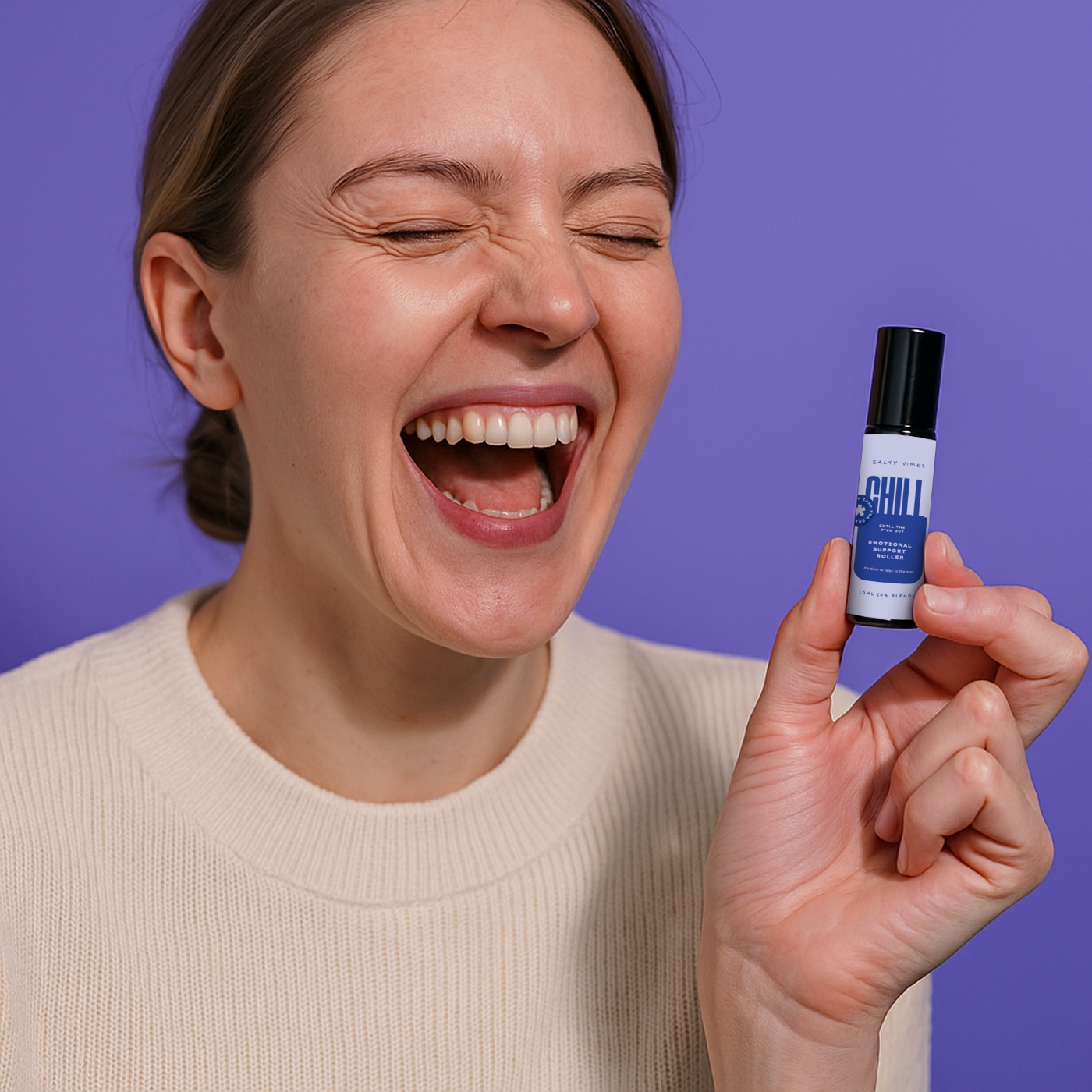 Woman laughing and holding a roller bottle labeled 'CHILL' against a purple background